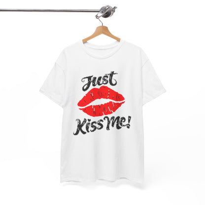 Chic hanging graphic t-shirt displaying the 'Just Kiss Me!' motif with striking red lips against a pristine white backdrop, a statement piece for fashion-forward wardrobes.