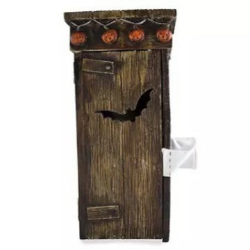 Spooky Outdoor Toilet Mummy Decoration - Side view of a luxurious plastic ornament depicting a mummy hiding behind a classic wooden toilet with festive pumpkin accents.
