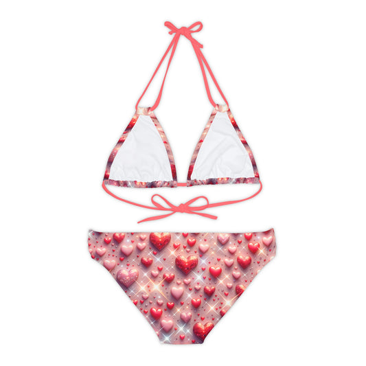 Chic Pastel Pink Strappy Bikini Set with charming glittering heart motifs, part of the Energetic Move Swimwear Collection, perfect for poolside relaxation.
