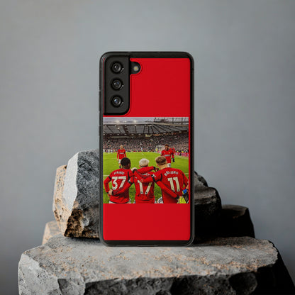 Stylish Manchester United Mainoo Garnach Hojlund Soft Phone Case sitting prominently on rugged stones, featuring a striking image of Manchester United players, ideal for soccer enthusiasts.