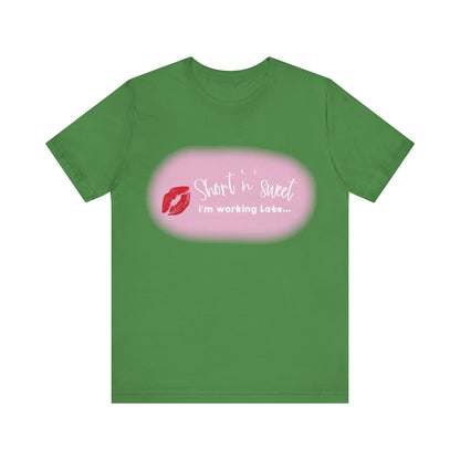Sabrina Carpenter Inspired Unisex Short Sleeve Tee in refreshing green featuring an eye-catching lipstick design and elegant phrase 'Short n sweet, i'm working Late...' embodying modern sophistication.