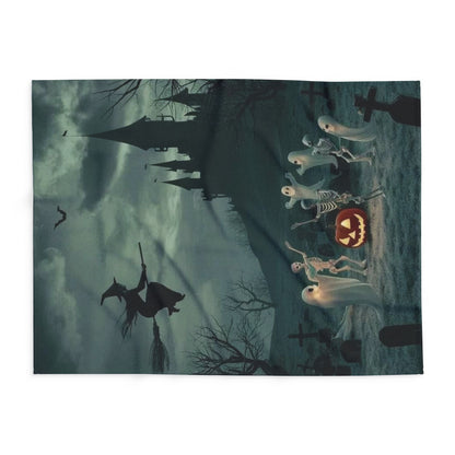 Elegant decorative and warm Halloween spooky Arctic fleece blanket laid flat, showcasing a haunting scene with a witch, ghosts, and skeletons alongside a jack-o'-lantern, ideal for festive décor during the Halloween season.