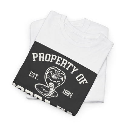 Stylishly folded white t-shirts with Cobra Kai logo, exuding a sense of luxury and casual sophistication for martial arts fans.