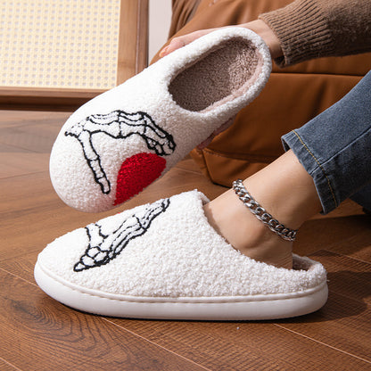 Stylish Funny Halloween Love Skull-hand Slippers with playful skull-hand design, soft plush material ideal for indoor lounging in winter, showcasing unique fashion.