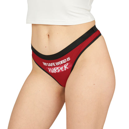 Stylish red women's thong being worn, showcasing the playful phrase 'MY SAFE WORD IS HARDER' in bold white lettering, perfect for romantic or humorous gifting.