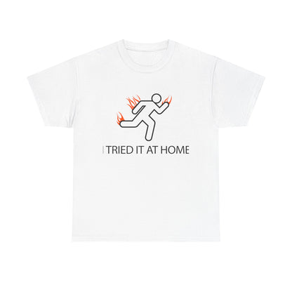 Luxury white men's t-shirt featuring an energetic stick figure running with vibrant flames design and the empowering phrase 'I TRIED IT AT HOME', perfect for fitness enthusiasts and motivational decor.