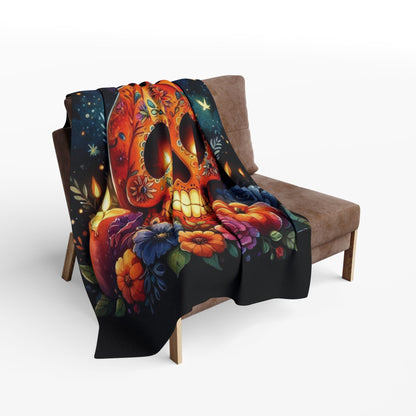Chic Decorative and Warm Halloween Spooky Arctic Fleece Blanket elegantly draped over a stylish armchair, featuring a stunning pumpkin skull design surrounded by flowers, perfect for Halloween aesthetics.