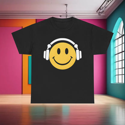 Enchanted Harmony Graphic T-Shirt in a sleek black colour, showcasing a bold yellow smiley face and white headphones design, set against a vibrant interior background.
