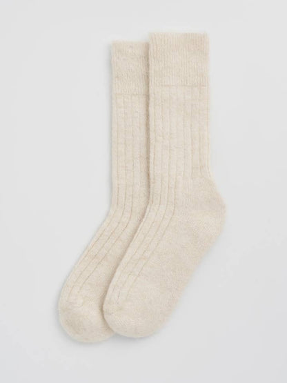 Elegant display of alpaca ribbed bed socks, exuding luxury with their stylish design and one-size-fits-most fit.