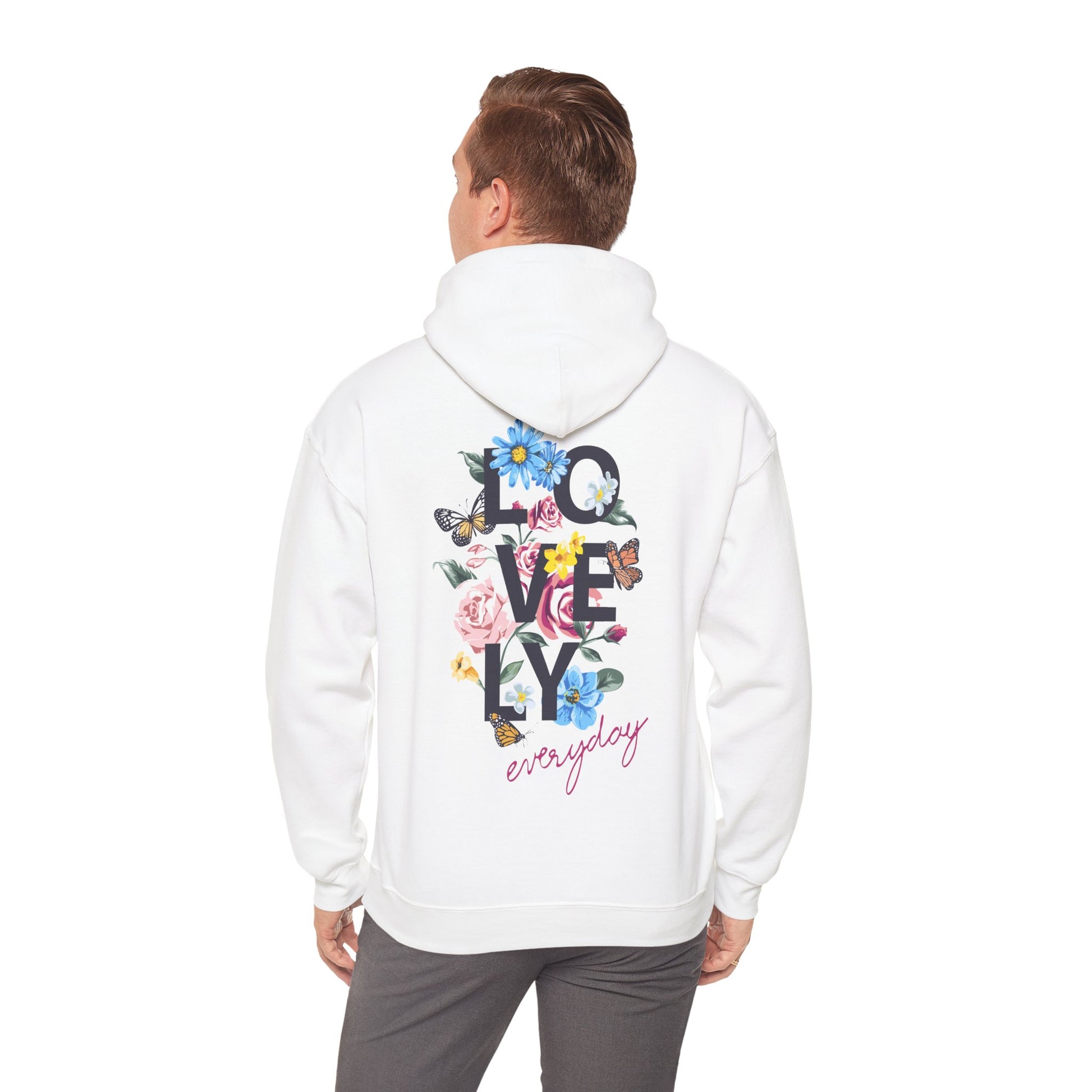 Stylish man wearing a white hoodie with a beautiful floral print, exemplifying casual elegance and comfort.