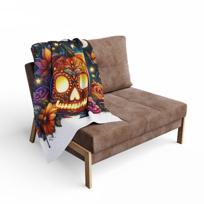 Stylish Decorative and Warm Halloween Skellington Spooky Arctic Fleece Blanket draped over a contemporary sofa, enhancing the festive atmosphere with its striking skull and floral artistry.