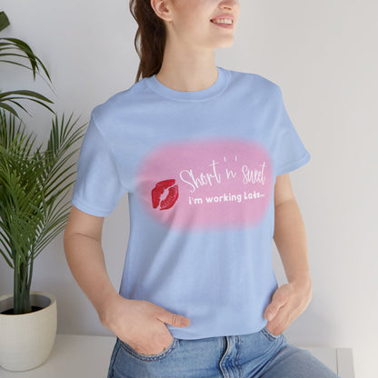 Sabrina Carpenter Inspired Unisex Short Sleeve Tee with Vibrant Lipstick Print, elegantly worn by a female model in light blue, showcasing the bold lipstick design with a trendy casual look.