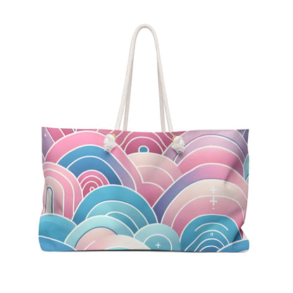 Marcella Kensington Chic Weekender Tote Bag by Dazzling Dreams Studio featuring a stunning pastel gradient pattern in soft pink, blue, and purple, complemented by stylish rope handles, perfect for luxurious travel aesthetics.