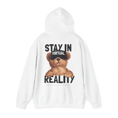 Elegant white hoodie showcasing a charming illustration of a teddy bear wearing VR goggles, complemented by striking text reading 'STAY IN VIRTUAL REALITY' and the phrase 'where dreams happen' in sophisticated lettering.