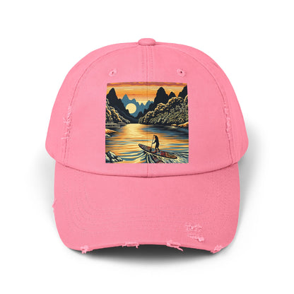 Unisex Distressed Paddleboarders Cap with Fantasy Design in pink, featuring a beautiful sunset paddleboarding illustration, ideal for luxury water excursions.