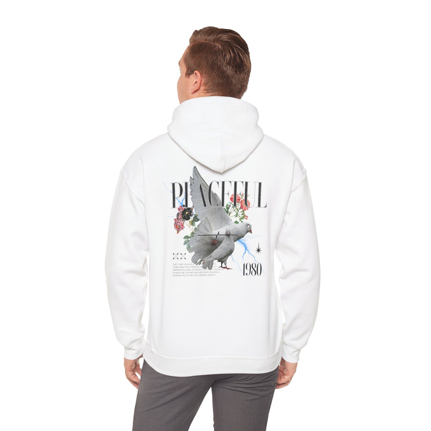 Model wearing a white hoodie with a striking dove graphic and floral elements on the back, combining comfort with a bold artistic statement.