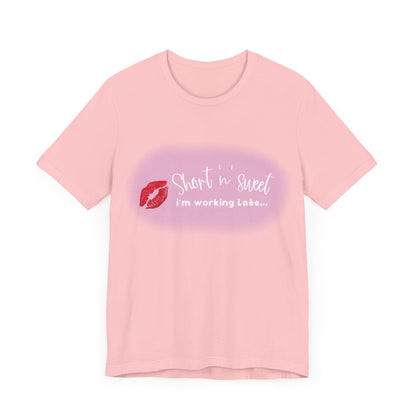 Sabrina Carpenter Inspired Unisex Short Sleeve Tee in soft pink, adorned with a vibrant lipstick print, reflecting chic style.