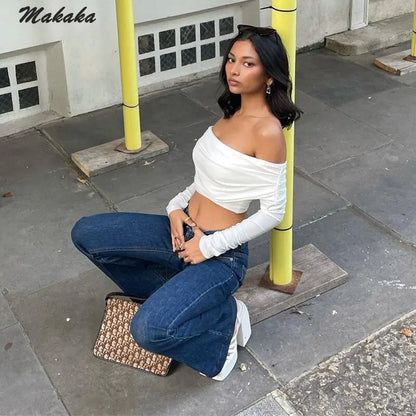 Stylish ensemble with the Chic Off-Shoulder Crop Sleeve Tee by Dazzling Dreams Studio paired with high-waisted trousers for a chic and youthful look.