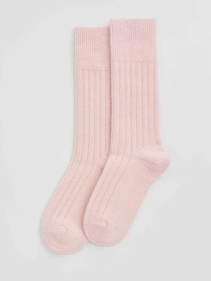 Close-up of luxury Merino bed socks displaying moisture-wicking fabric and odour-resistant properties, ideal for a restful night's sleep.
