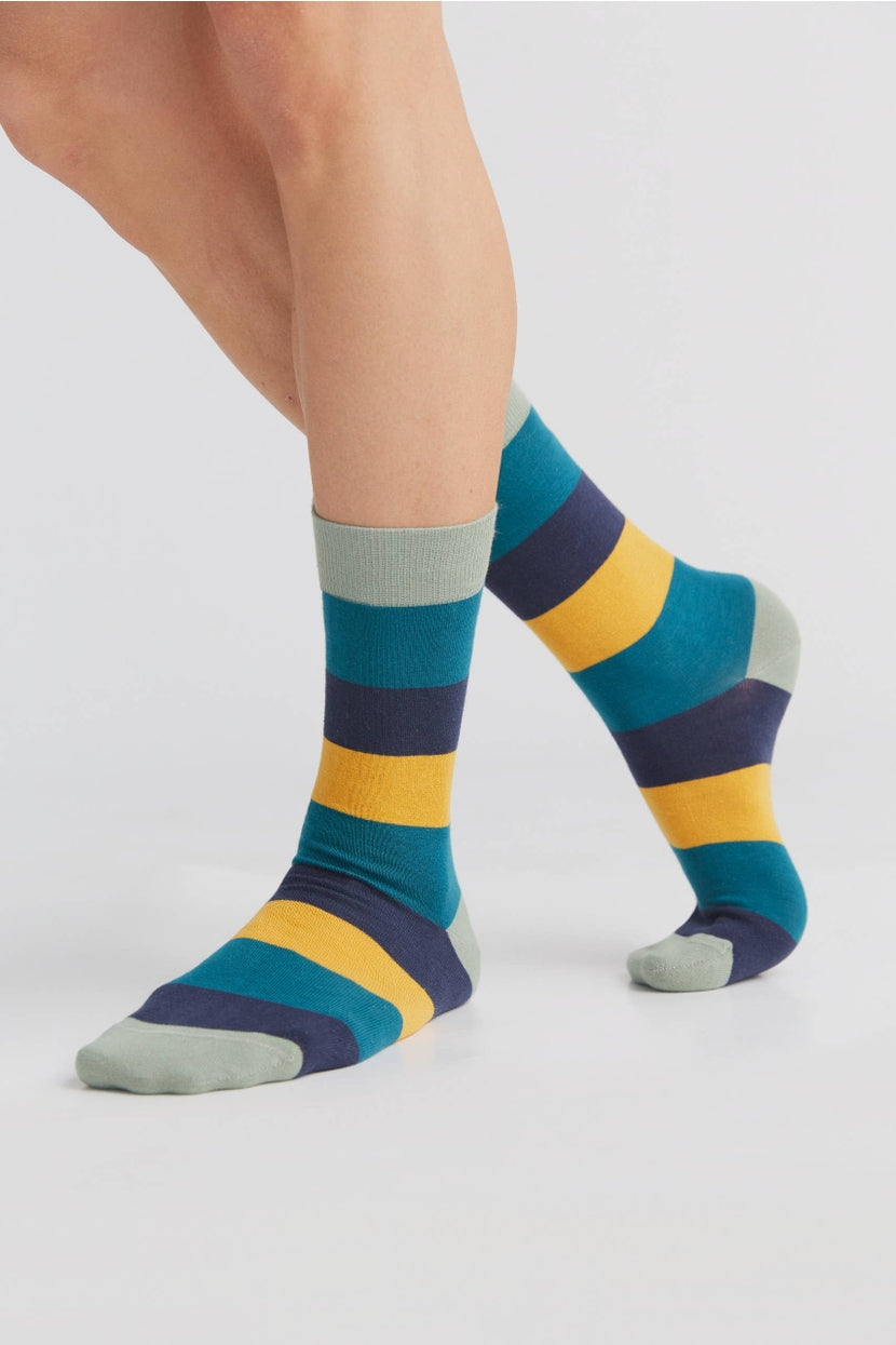 Luxury organic cotton socks presented with a stylish cuff, emphasizing sustainable materials and comfort in a chic packaging.