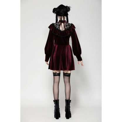 Model elegantly wearing the burgundy velvet dress with black gothic lace at a glamorous event, highlighting its luxurious design.