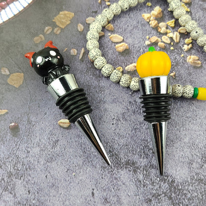 Two elegantly designed Halloween Sealed Stopper Vacuum Resin Wine Bottle Stoppers featuring a playful cat and pumpkin motif, perfect for wine enthusiasts looking to elevate their festive table setting.