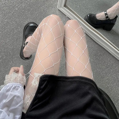 Charming Women's Luxury Fishnet Design Tights in white, displayed elegantly with black shoes, reflecting a fashionable and luxurious aesthetic.