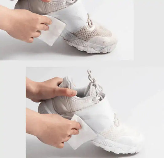 A person using Quick Shoe Wipes to effortlessly clean a stylish white sneaker, showcasing the ease of footwear maintenance.