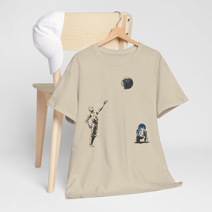 Elegant Star Wars T-Shirt featuring C-3PO and R2-D2 playfully interacting with a Death Star balloon, styled on a wooden chair with a cap, ideal for fashion-forward fans.