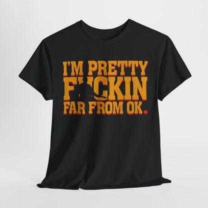 Stylish black unisex graphic t-shirt featuring the empowering phrase 'I'M PRETTY FICKIN FAR FROM OK.' in bold mustard yellow and reddish-orange hues, perfect for making a statement in urban fashion.