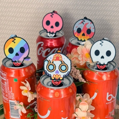 Luxurious Skull Design Soda Can Tab Opener with Keychain Strap, displayed atop vibrant soda cans, showcasing an artistic and unique accessory for effortless beverage opening.