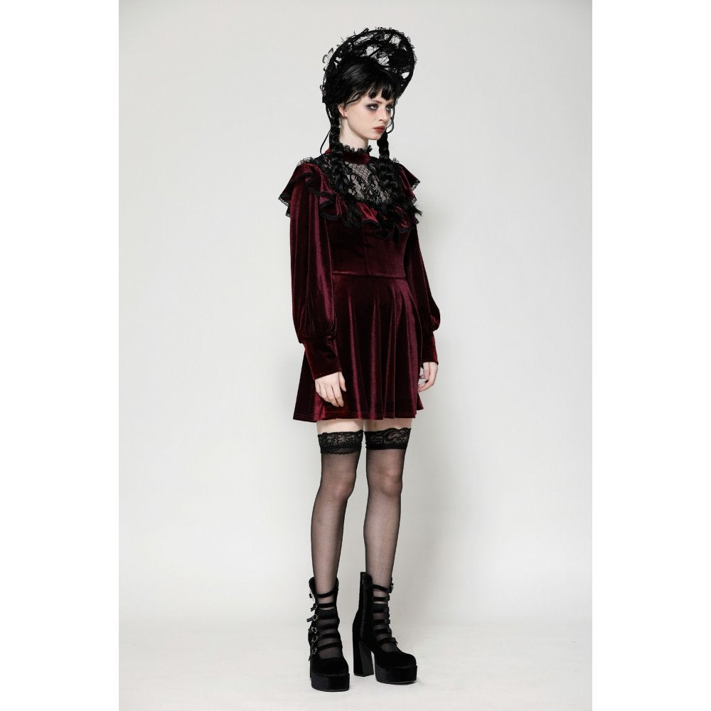 Close-up of the intricate black gothic lace overlay on the lush burgundy velvet dress, showcasing the ruffle neckline.