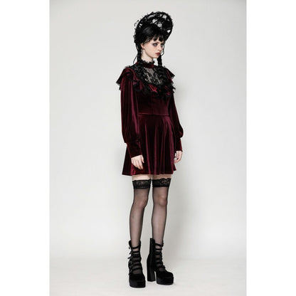 Close-up of the intricate black gothic lace overlay on the lush burgundy velvet dress, showcasing the ruffle neckline.