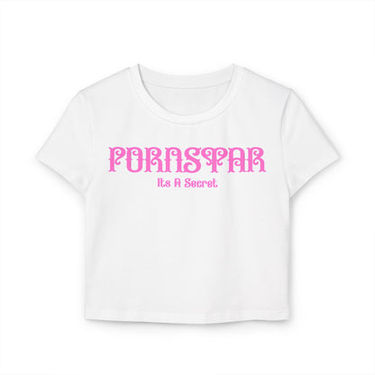 Cheeky women's cropped t-shirt in white, featuring a playful graphic design with the word 'PORNSTAR' in stylised pink font closely followed by the phrase 'It’s A Secret', crafted from luxurious 100% organic cotton.