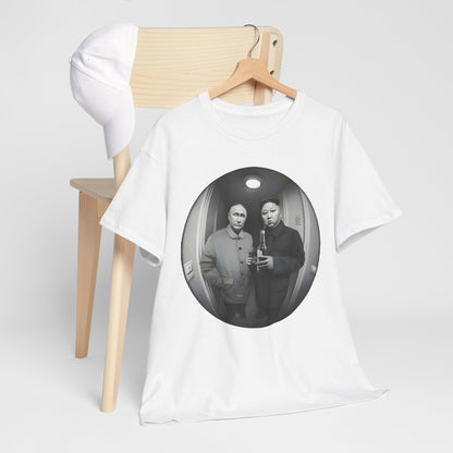 Stylish graphic t-shirt displayed alongside a cap, featuring a whimsical design of world leaders, ideal for a luxe casual look.