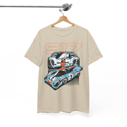 Beige t-shirt elegantly displayed on a hanger, showcasing a luxurious graphic design of two Porsche 917 cars with vivid orange detailing.