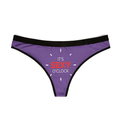 Stylish women's thong in vibrant purple showcasing the fun phrase 'It's Sexy O'Clock' in striking red, perfect for adding a touch of humour to intimate apparel.