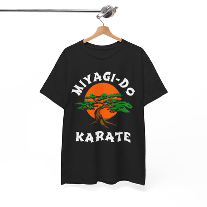 Framed Miyagi-Do Karate graphic T-shirt on display, embodying sophisticated fandom with its unique design of a tree set against an orange sun.