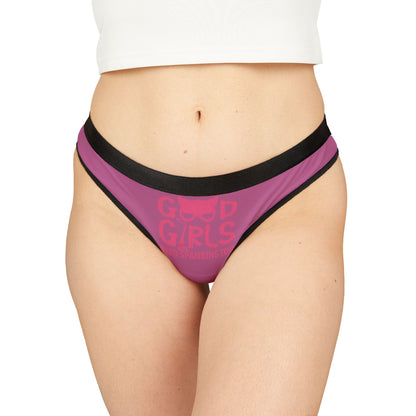 Luxurious pink women's thong with playful 'Good Girls Need Spanking Too' graphic design, featuring elegant black trim, perfect for romantic occasions.