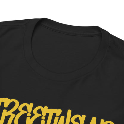 Close-up view of a luxurious black t-shirt collar, featuring prominent yellow streetwear textual design, emphasizing quality craftsmanship.