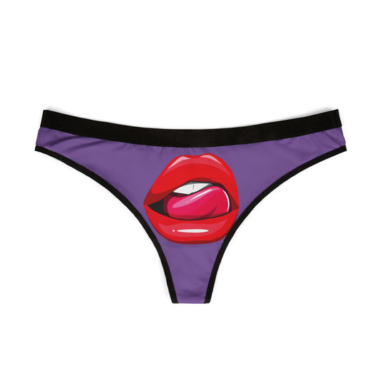 Luxury women's thong featuring a playful graphic of luscious red lips and a pink tongue on a vibrant purple background, perfect for cheeky gifting.