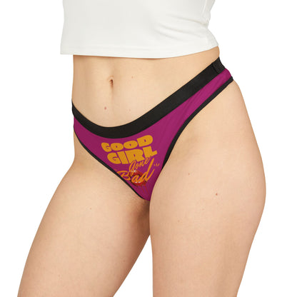 Model wearing exquisite purple thong panties with the phrase 'Good Girl Gone Bad,' showcasing a chic and playful style.