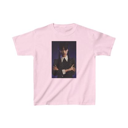 Child's 'Wednesday': Embrace the Dark Elegance! Graphic Unisex Tee in soft pink capturing a powerful image of a young girl with raven hair in pigtails, elegantly dressed in a dark striped jacket, representing the enigma of Wednesday Addams.