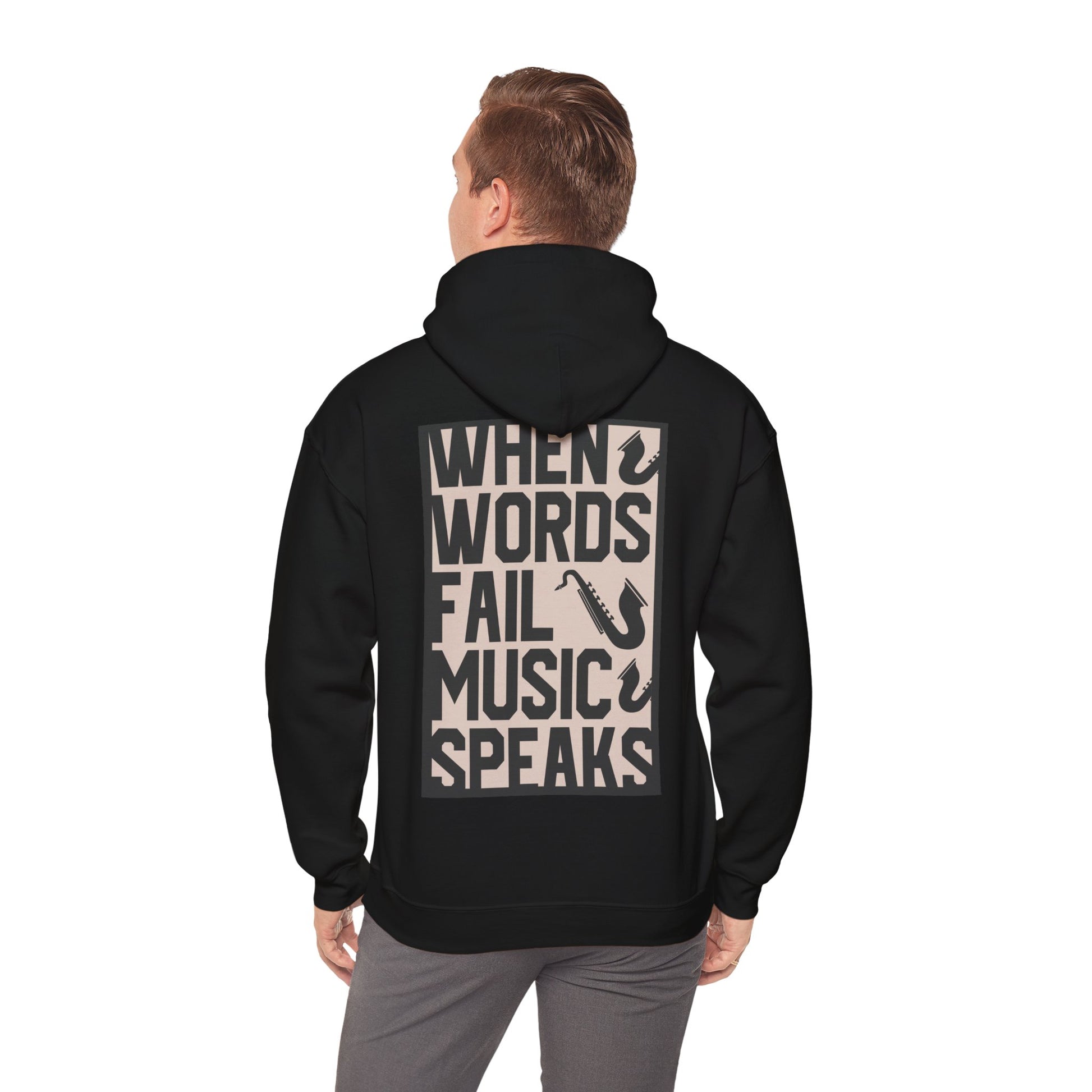 Refined back view of a black hoodie displaying the impactful message 'WHEN WORDS FAIL MUSIC SPEAKS' with saxophone graphics, suitable for music aficionados.