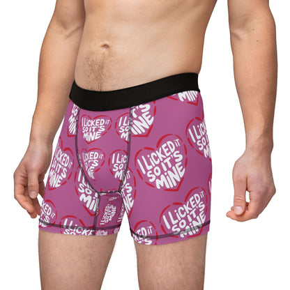 A model wearing Valentine's Naughty Cheeky Men's Boxer Briefs, proudly displaying the cheeky phrase 'I LICKED IT SO IT'S MINE' amidst charming heart patterns, ideal for birthdays or anniversaries.