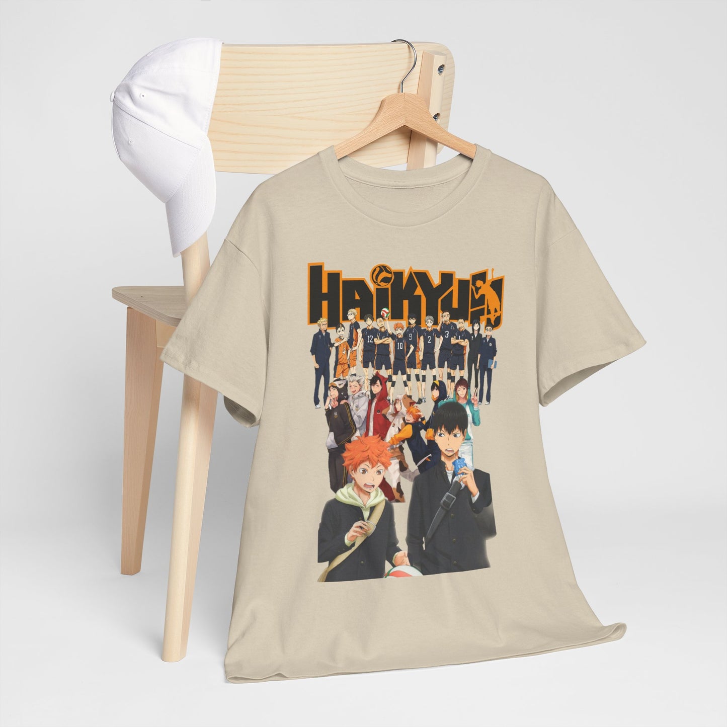 Haikyuu!! T-shirt displayed elegantly on a chair alongside a cap, showcasing a vibrant design that appeals to both anime lovers and fashion aficionados.
