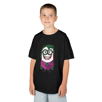 A young boy posing in a Minions Joker T-Shirt that showcases a cartoonish Minion styled as the Joker. This funny children's shirt combines Minions and comic book themes, making it a great choice for fans.