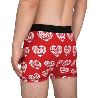 Side profile of a man wearing Valentine's Naughty Cheeky Men's Boxer Briefs, featuring a cheeky pattern with hearts and the slogan 'I LICKED IT SO IT'S MINE', ideal for a unique romantic gift.