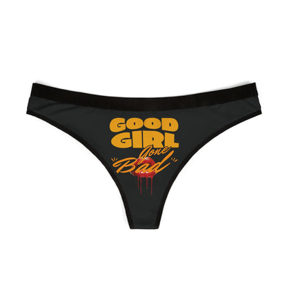 Luxurious women's thong featuring 'Good Girl Gone Bad' graphic design in vibrant orange on elegant black fabric, showcasing a cheeky aesthetic.