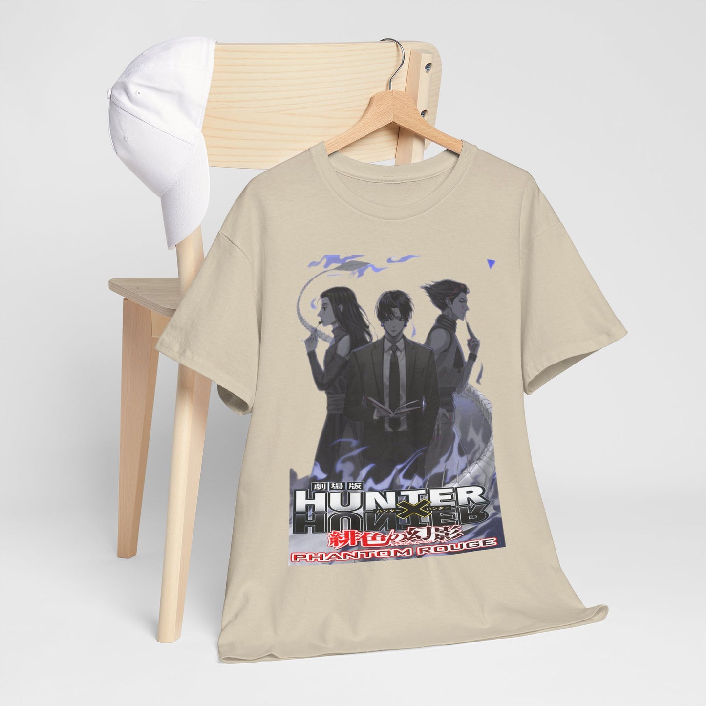Sophisticated photography of a Hunter x Hunter T-shirt draped over a chair alongside a stylish cap, epitomising luxury anime fashion.